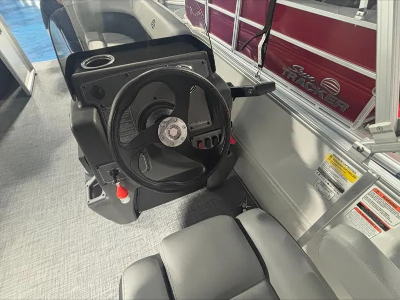 Slide: The Image of 2026 Sun Tracker PB 16 DLX boat steering console with modern design and controls. - 8