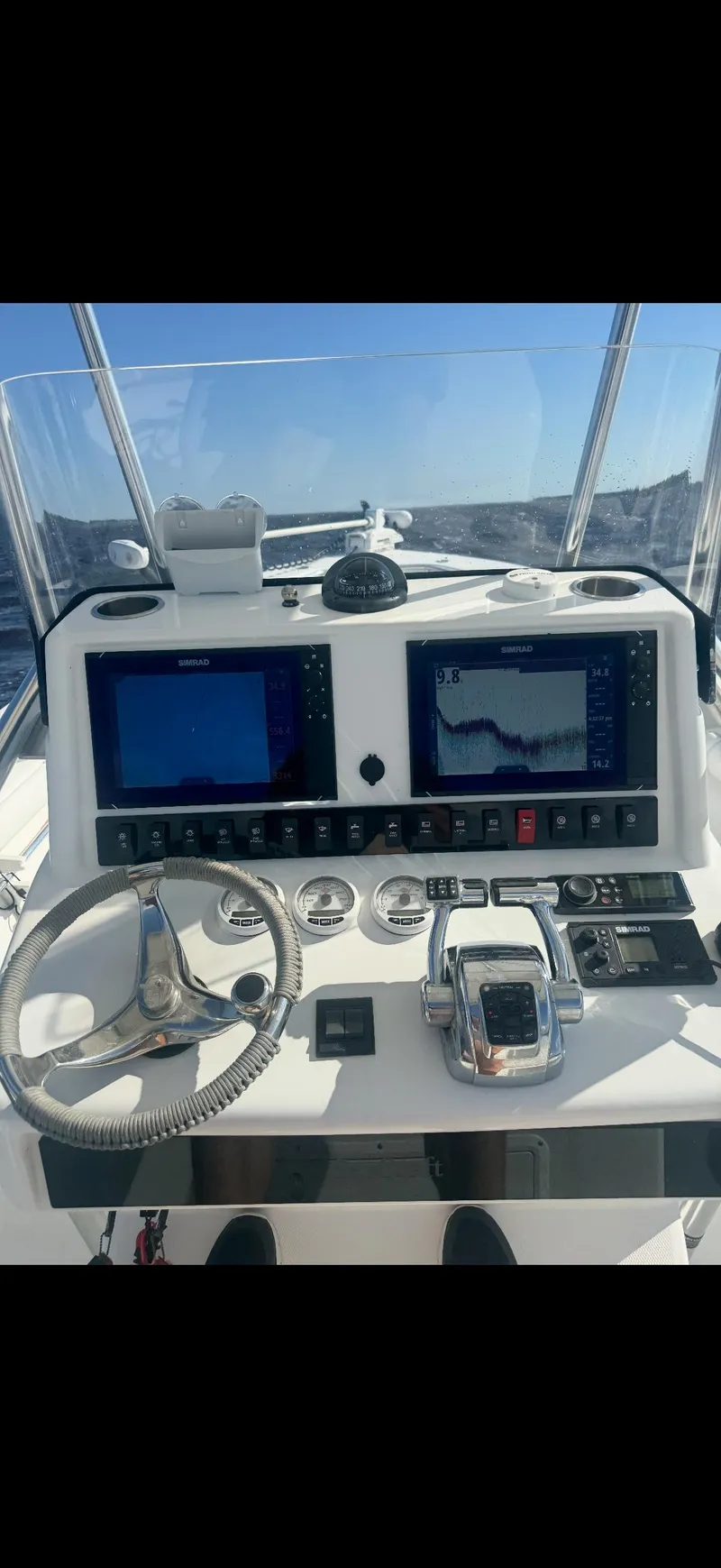Slide: The Image of 2007 SeaCraft 25 boat dashboard with dual navigation screens and steering wheel. - 5