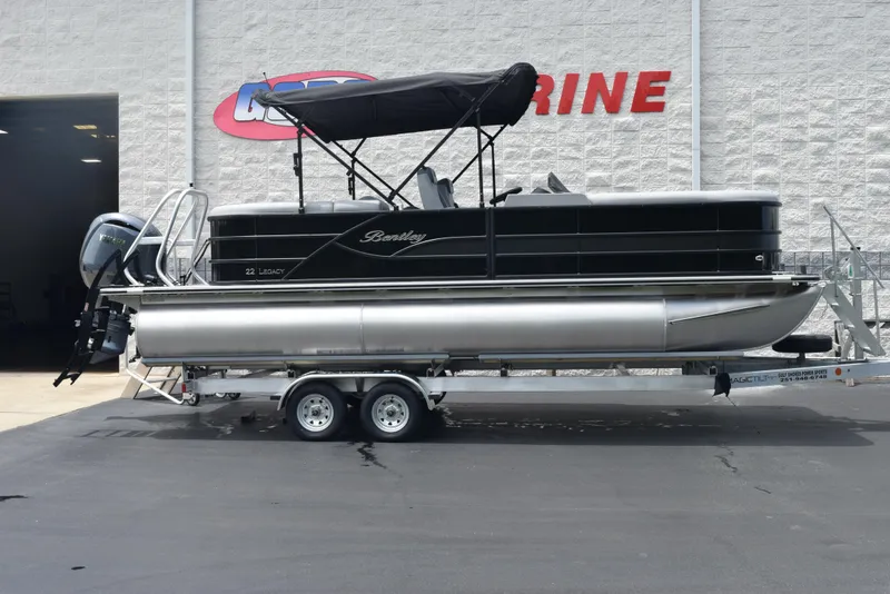 Slide: The Image of 2026 Bentley Pontoons Legacy 223 Navigator on trailer outside marine shop. - 1