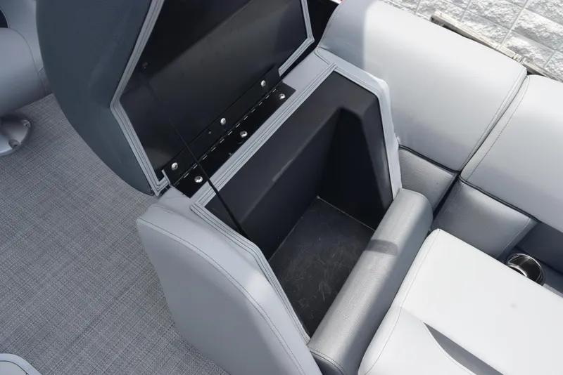 Slide: The Image of 2026 Bentley Pontoons Legacy 223 Navigator storage compartment with open seat and gray upholstery. - 17