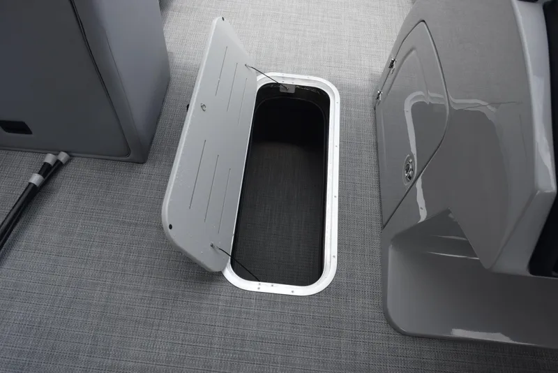 Slide: The Image of Open storage compartment on 2026 Bentley Pontoons Legacy 223 Navigator boat. - 23