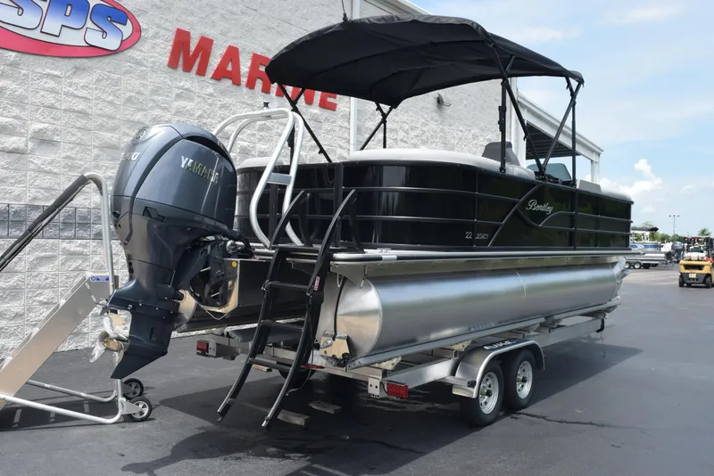 Slide: The Image of 2026 Bentley Pontoons Legacy 223 Navigator on trailer, with Yamaha outboard motor. - 4