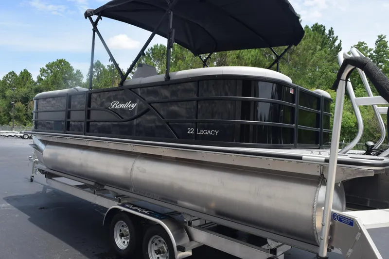 Slide: The Image of 2026 Bentley Pontoons Legacy 223 Navigator on trailer, black exterior, parked outdoors. - 6