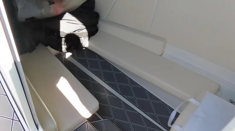 Slide: The Image of 2019 Sunsation 32 CCX interior with cushioned seating and patterned flooring. - 18