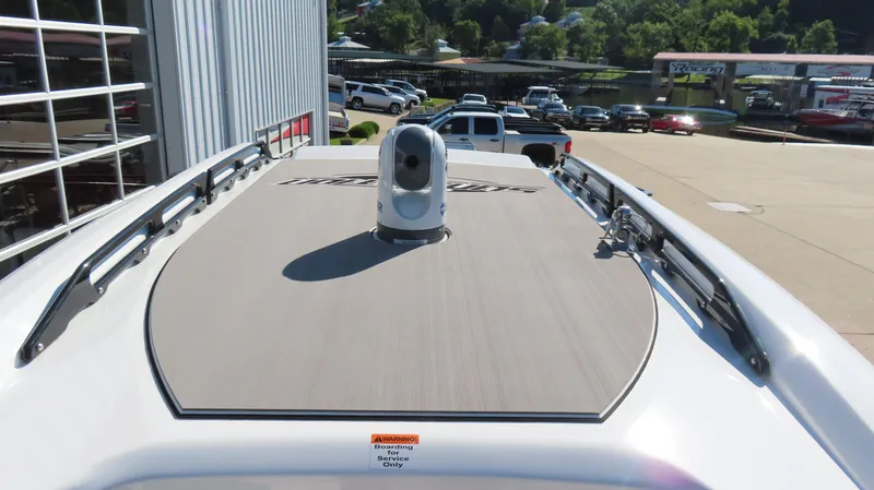Slide: The Image of 2019 Sunsation 32 CCX boat deck with radar, parked near a marina. - 19