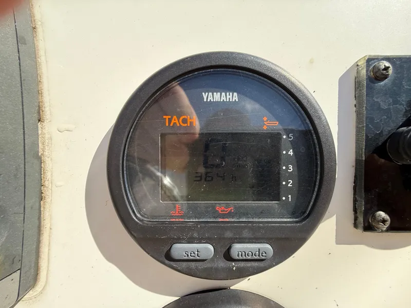 Slide: The Image of Yamaha tachometer on 2015 Hewes Redfisher 18 boat dashboard, displaying engine hours. - 11