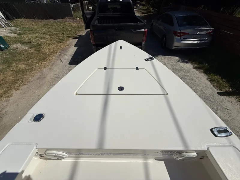 Slide: The Image of 2015 Hewes Redfisher 18 boat on trailer, parked in driveway. - 12