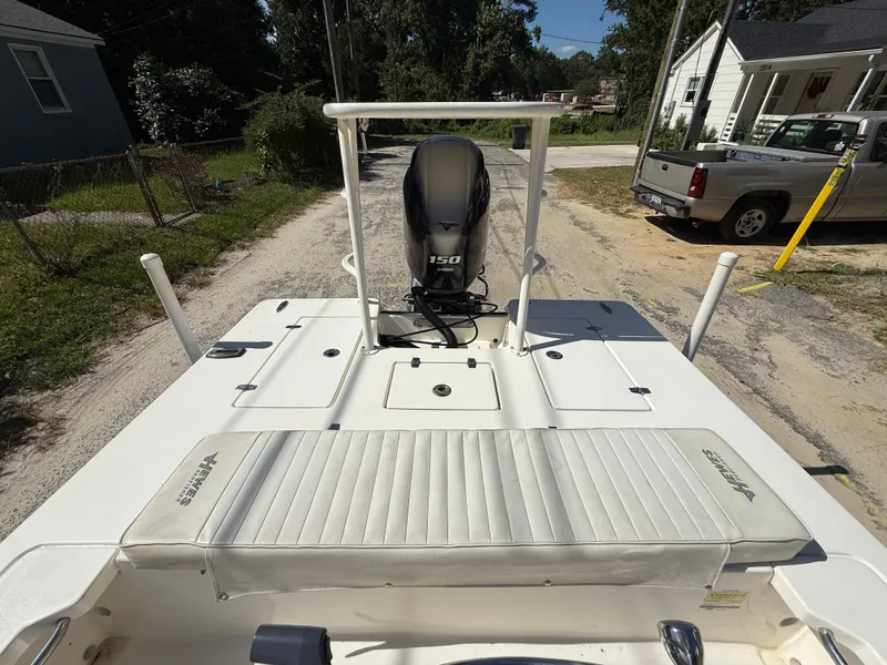 Slide: The Image of 2015 Hewes Redfisher 18 boat with Yamaha 150 engine on a residential street. - 13