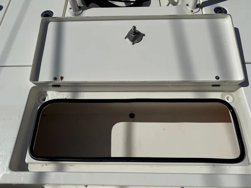 Slide: The Image of Open storage compartment on a 2015 Hewes Redfisher 18 boat. - 15