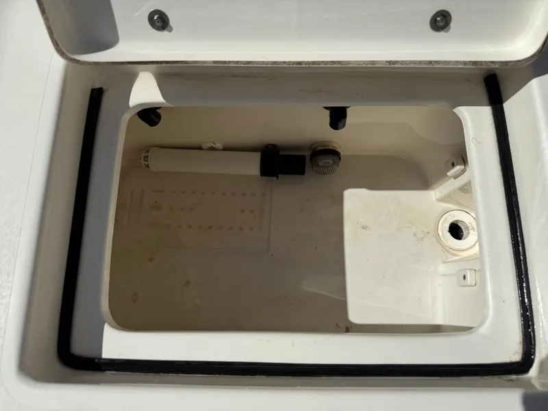 Slide: The Image of Open storage compartment in 2015 Hewes Redfisher 18 boat, showing interior details. - 16