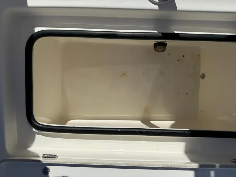 Slide: The Image of Open storage compartment on a 2015 Hewes Redfisher 18 boat. - 17