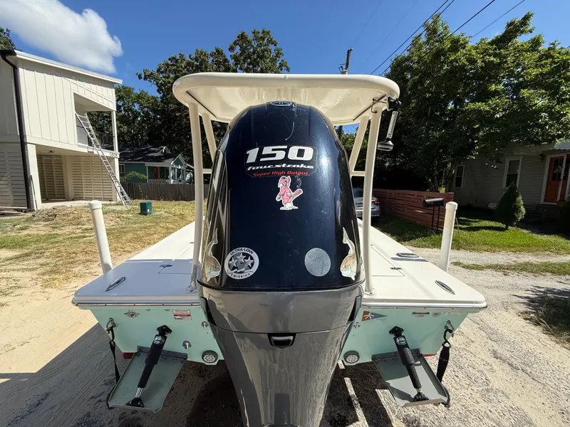 Slide: The Image of 2015 Hewes Redfisher 18 boat with 150 horsepower engine, parked outdoors. - 5