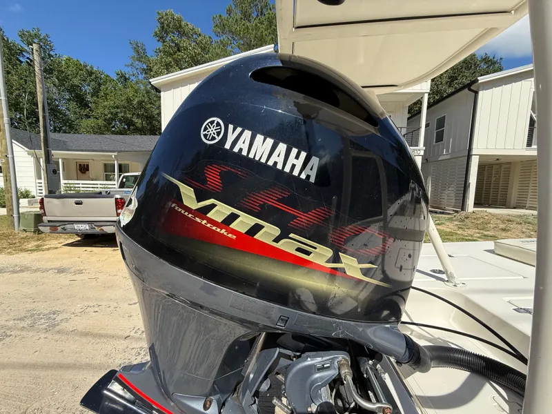 Slide: The Image of Yamaha VMAX outboard motor on 2015 Hewes Redfisher 18 boat, parked outdoors. - 7