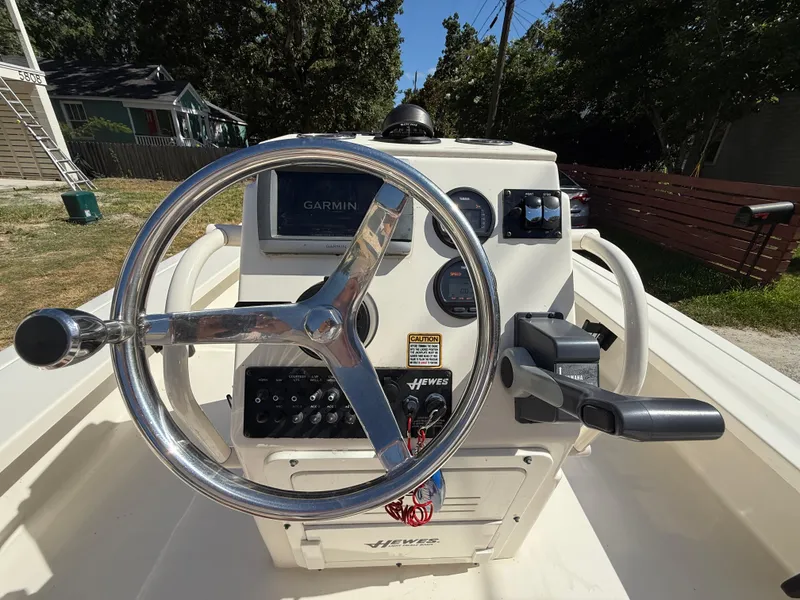 Slide: The Image of 2015 Hewes Redfisher 18 boat console with Garmin display and steering wheel. - 8
