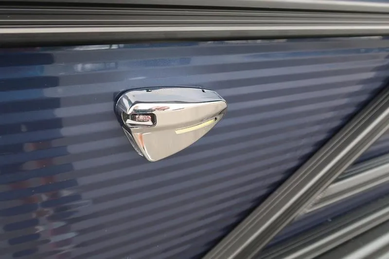 Slide: The Image of 2026 Bennington S Swingback 22 SSB, sleek chrome detail on blue exterior. - 15