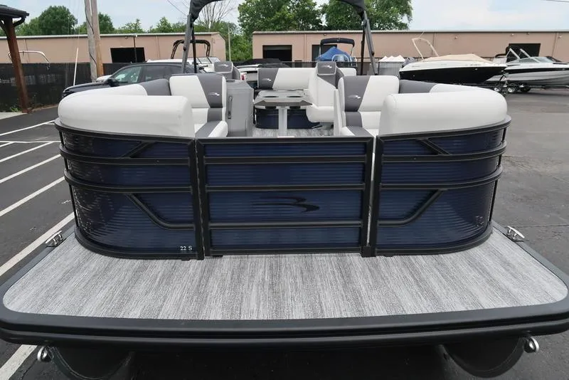 Slide: The Image of 2026 Bennington S Swingback 22 SSB pontoon boat, rear view, in a parking lot. - 17
