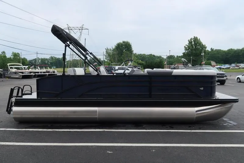 Slide: The Image of 2026 Bennington S Swingback 22 SSB pontoon boat parked outdoors. - 2