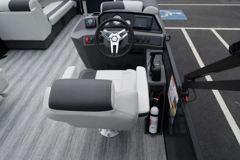Slide: The Image of 2026 Bennington S Swingback 22 SSB boat helm with steering wheel and captain's chair. - 23
