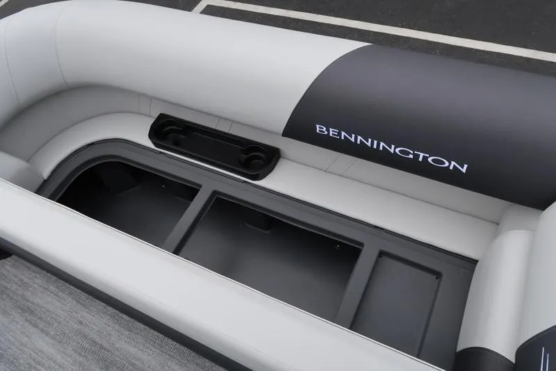 Slide: The Image of 2026 Bennington S Swingback 22 SSB boat interior with storage compartment and cup holders. - 33