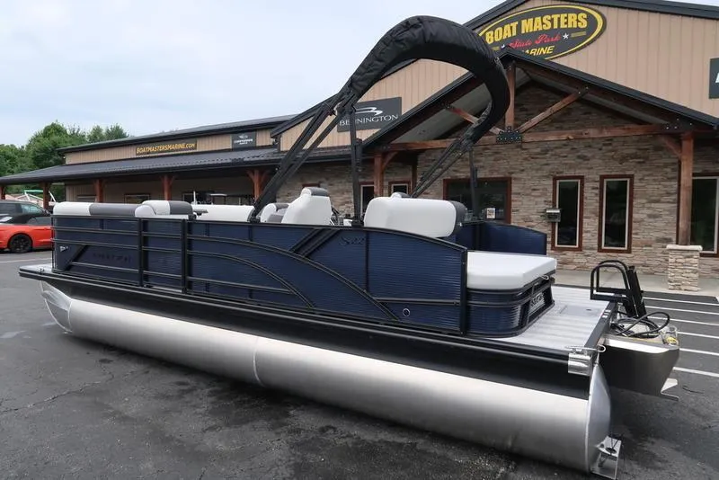 Slide: The Image of 2026 Bennington S Swingback 22 SSB pontoon boat parked at dealership. - 6