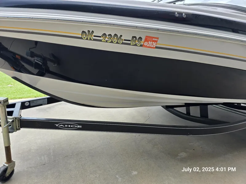 Slide: The Image of 2006 Tahoe Q6 SF boat on trailer, registration sticker visible, photographed on July 2, 2025. - 2