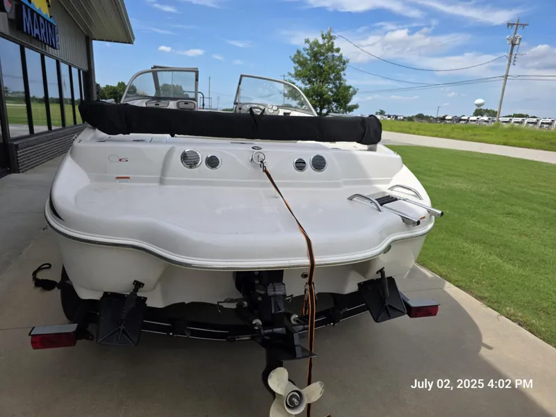 Slide: The Image of 2006 Tahoe Q6 SF boat parked outside a marine shop on a sunny day. - 3
