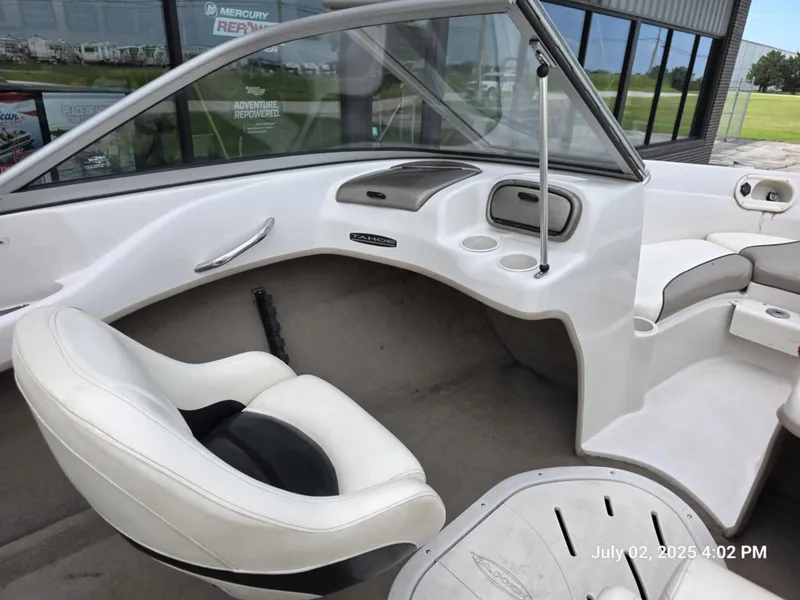 Slide: The Image of Interior of a 2006 Tahoe Q6 SF boat with white seating and dashboard. - 5