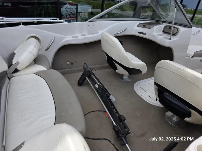 Slide: The Image of Interior of a 2006 Tahoe Q6 SF boat with white seating and steering area. - 7