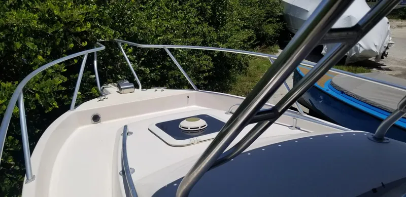 Slide: The Image of 1993 Intrepid 26 Walkaround boat deck with railing, surrounded by greenery. - 11