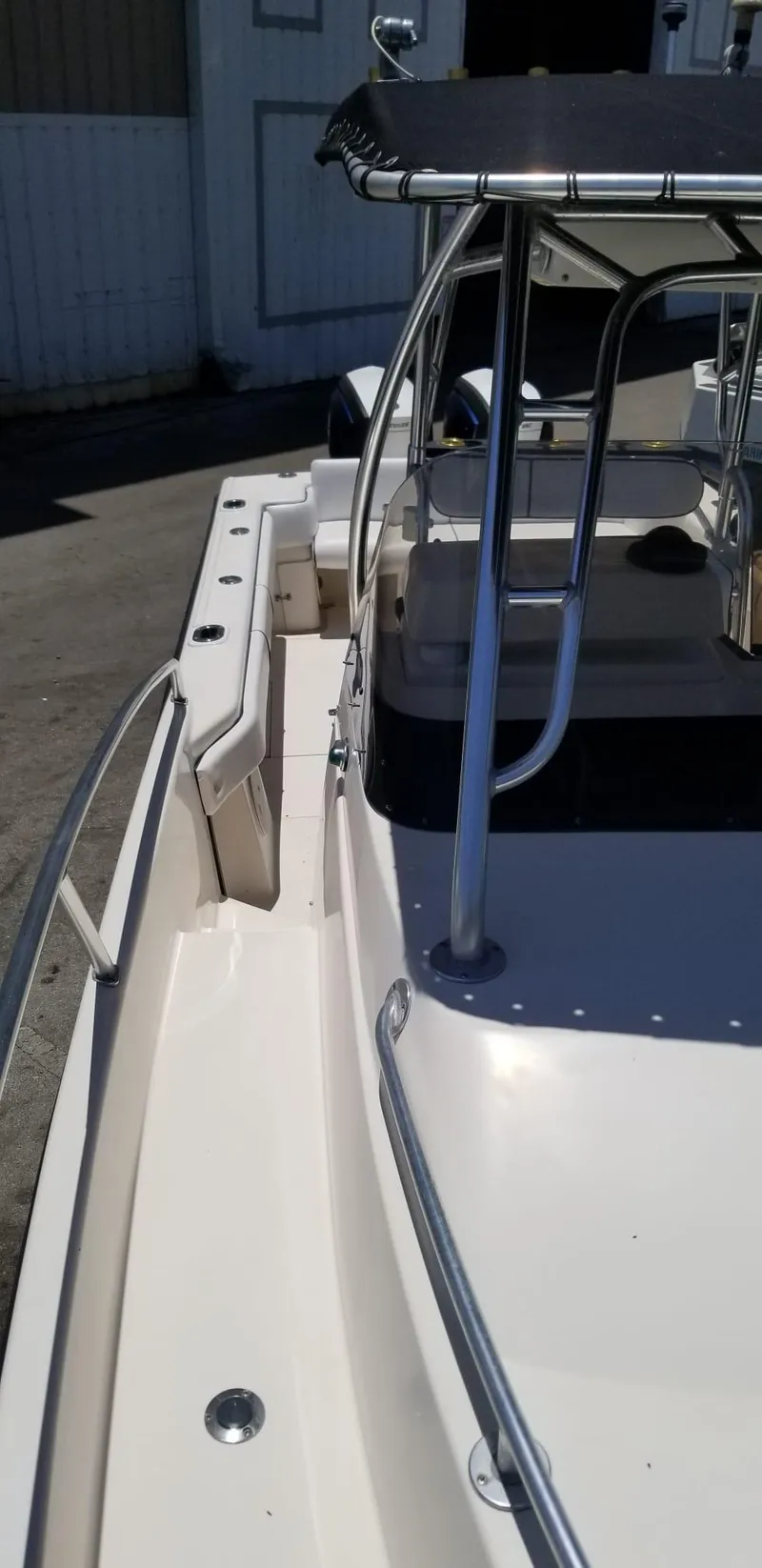 Slide: The Image of 1993 Intrepid 26 Walkaround boat with stainless steel railings and canopy. - 12