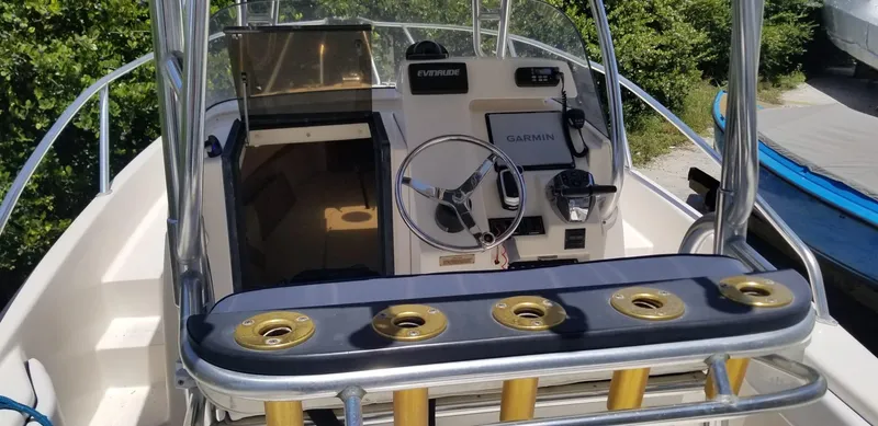 Slide: The Image of 1993 Intrepid 26 Walkaround boat cockpit with steering wheel and navigation equipment. - 18