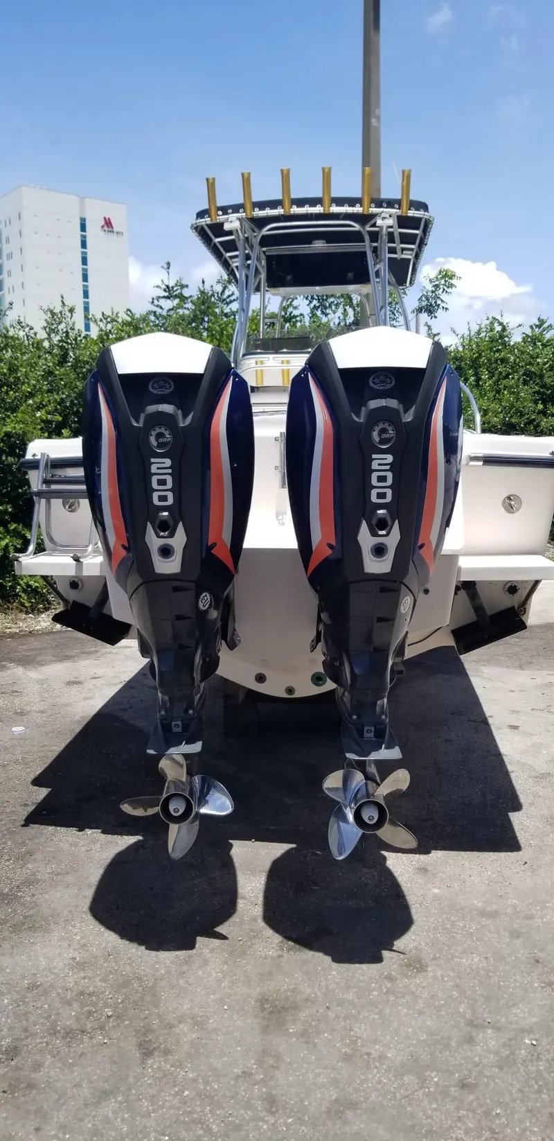 Slide: The Image of 1993 Intrepid 26 Walkaround boat with dual 200 horsepower outboard engines, docked outdoors. - 19