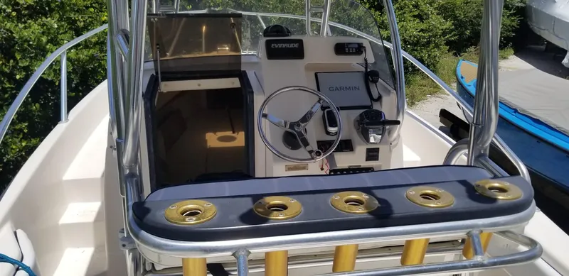 Slide: The Image of 1993 Intrepid 26 Walkaround boat cockpit with Garmin navigation system and rod holders. - 20