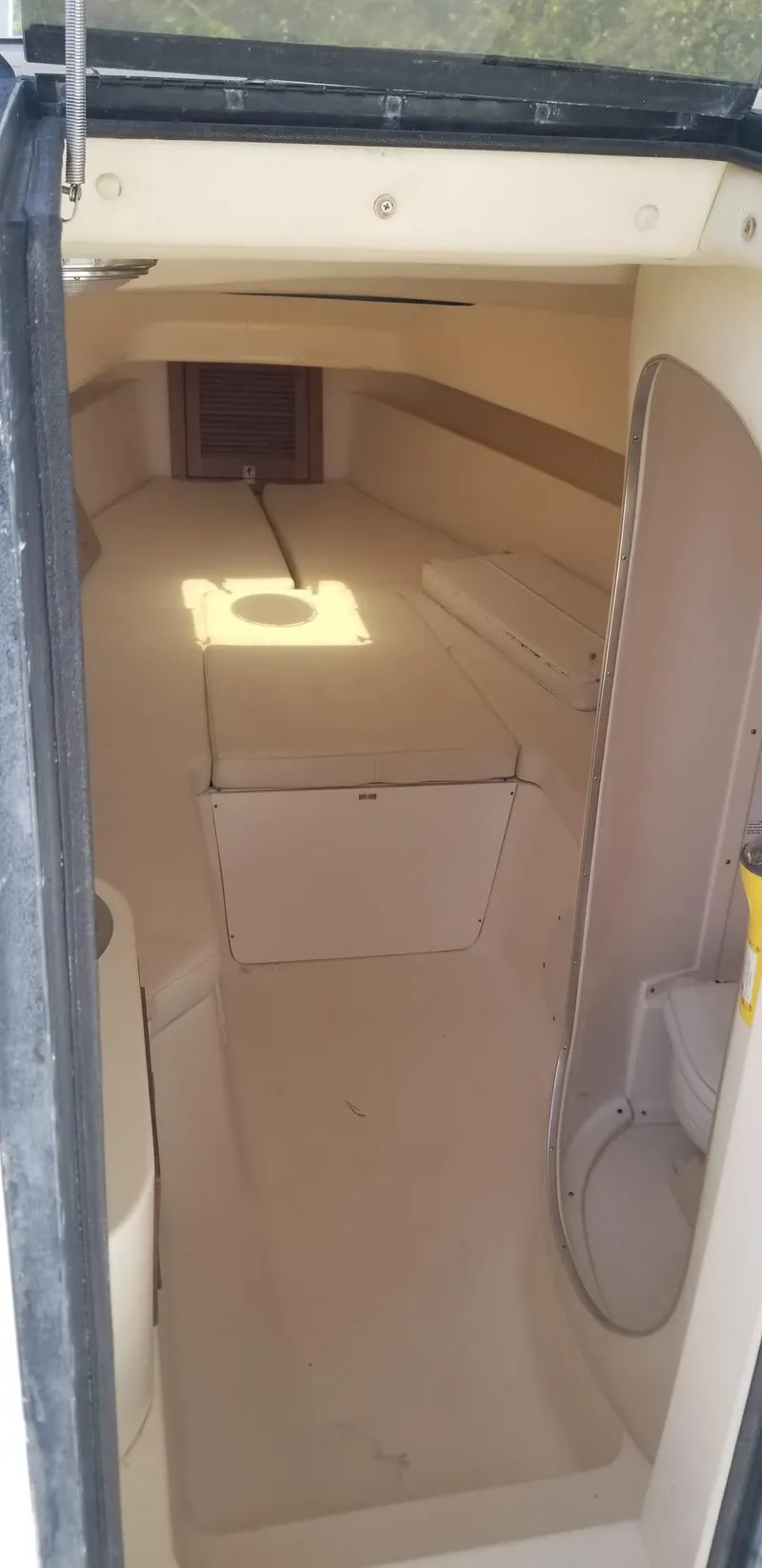 Slide: The Image of 1993 Intrepid 26 Walkaround cabin interior with seating and storage. - 21