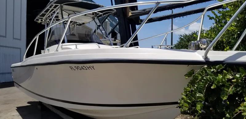 Slide: The Image of 1993 Intrepid 26 Walkaround boat docked, featuring sleek design and sturdy railings. - 3