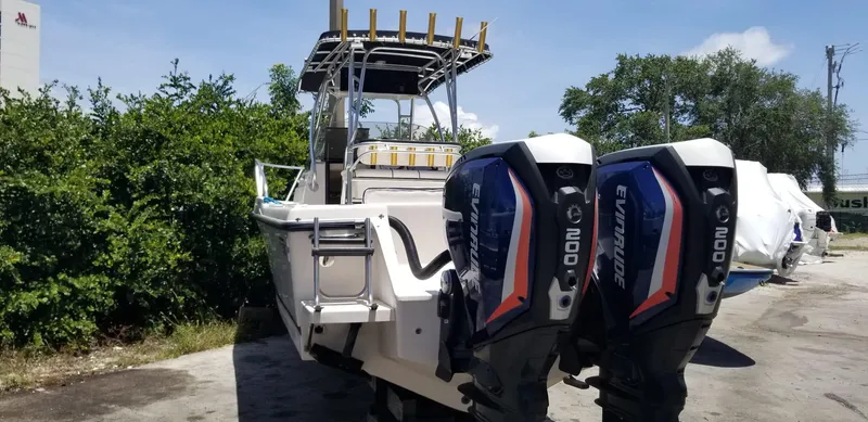 Slide: The Image of 1993 Intrepid 26 Walkaround boat with dual Evinrude 200 engines, parked outdoors. - 6