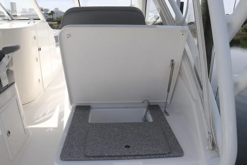 Slide: The Image of 2021 Albemarle 31 DC boat interior with open storage compartment and sink. - 12