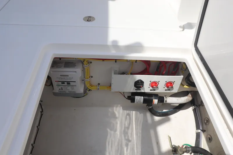 Slide: The Image of Electrical compartment of 2021 Albemarle 31 DC boat, featuring wiring and control switches. - 18