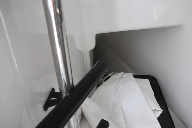 Slide: The Image of Interior of 2021 Albemarle 31 DC boat showing storage area with white fabric. - 26