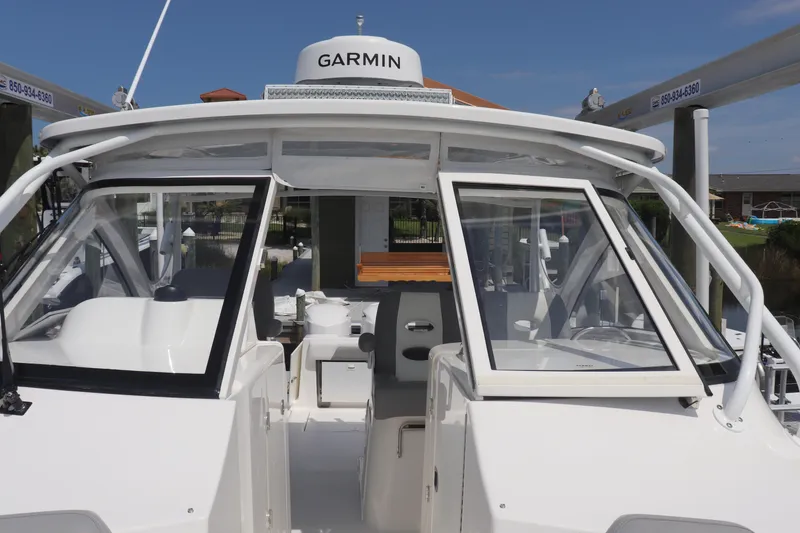 Slide: The Image of 2021 Albemarle 31 DC boat with Garmin equipment, docked under clear skies. - 35