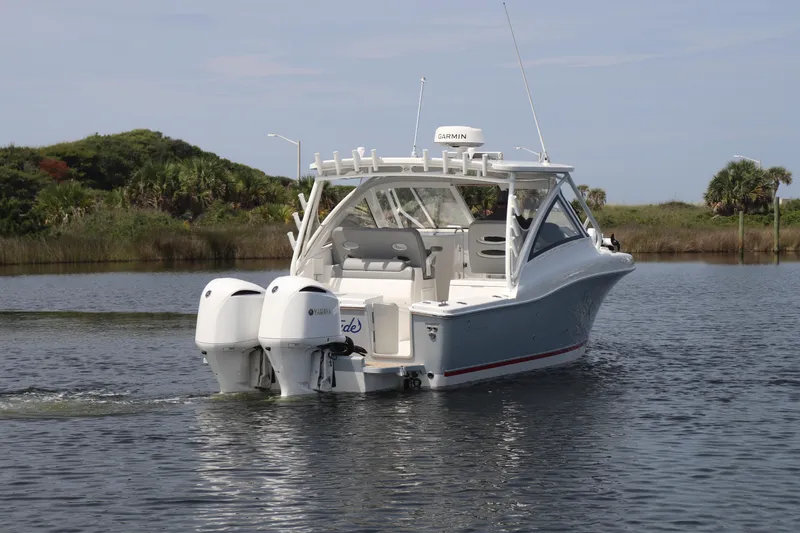 Slide: The Image of 2021 Albemarle 31 DC boat with twin Yamaha engines on a calm waterway. - 4