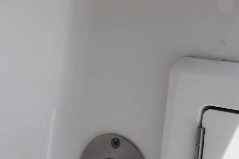 Slide: The Image of Close-up of 2021 Albemarle 31 DC boat interior detail, featuring a metal fixture and hinge. - 42