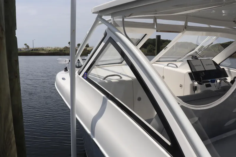 Slide: The Image of 2021 Albemarle 31 DC boat docked, featuring sleek design and modern navigation equipment. - 48