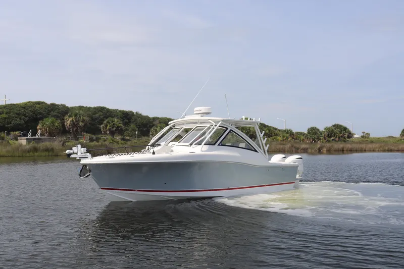 Slide: The Image of 2021 Albemarle 31 DC boat cruising on a calm waterway. - 6