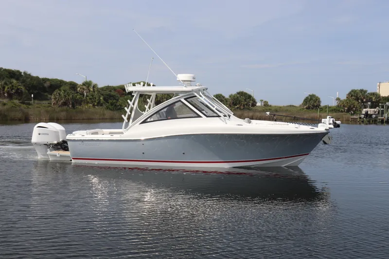 Slide: The Image of 2021 Albemarle 31 DC boat on calm water, featuring sleek design and modern outboard motor. - 7