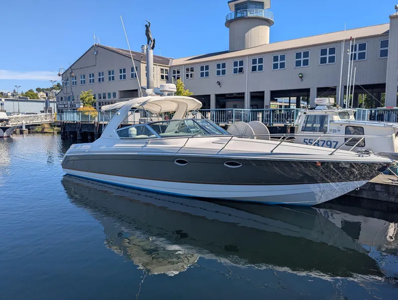 Slide: The Image of 2003 Formula 330 SS boat docked at marina with building in background. - 1
