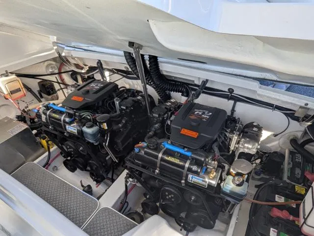 Slide: The Image of Engine compartment of a 2003 Formula 330 SS boat, featuring dual engines and clean layout. - 14
