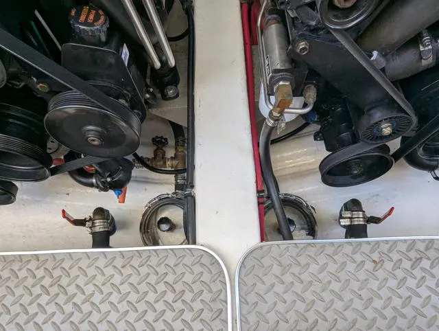 Slide: The Image of Engine compartment of a 2003 Formula 330 SS boat, showing mechanical components and piping. - 16