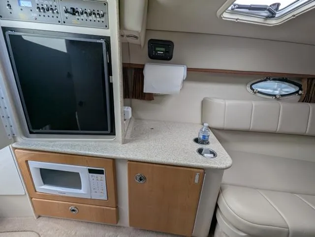 Slide: The Image of Interior of a 2003 Formula 330 SS boat with kitchenette and seating area. - 17