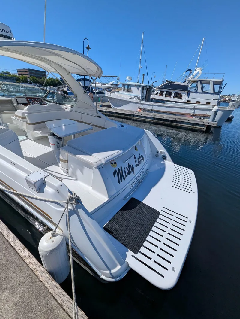 Slide: The Image of 2003 Formula 330 SS boat docked at marina, clear blue sky, other boats in background. - 3